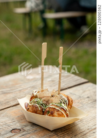 Takoyaki - traditional Japanese street food, outdoor snack with octopus Takoyaki fried balls 128000362