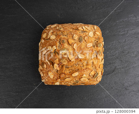 Pumpkin seeds bread, breakfast roll with pepita seeds. Fitness square bun, healthy burger Pumpkin seeds bread, breakfast roll with pepita seeds. Fitness square bun, healthy burger 128000394