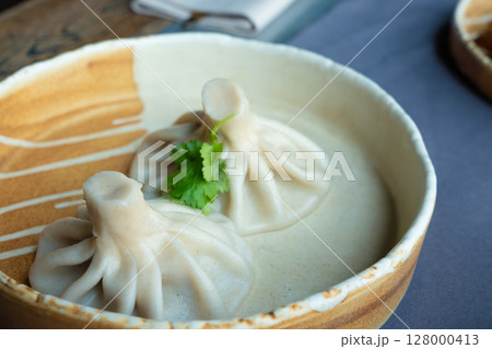 Georgian khinkali or chinkali with minced meat. Traditional spicy Georgian steamed dumplings 128000413