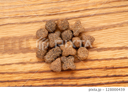 Dry pet food macro pieces, cat kibble closeup, dog pellets, small protein croquettes detailed 128000439
