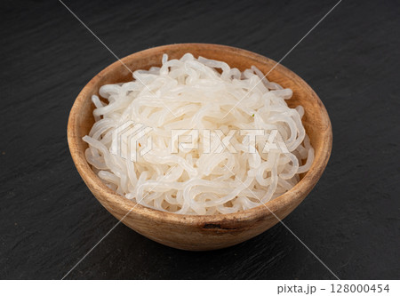 Shirataki or konnyaku pasta in wood bowl. Konjak jelly noodles, Japanese zero calorie sirataki Shirataki or konnyaku pasta in wood bowl. Konjak jelly noodles, Japanese zero calorie sirataki 128000454