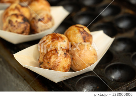 Takoyaki - traditional Japanese street food, Osaka outdoor snack with octopus, takoyaki fried balls 128000806