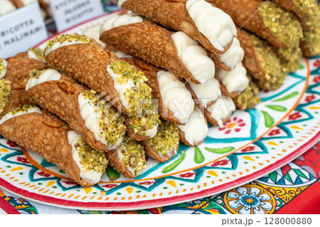 Cannoli with pistachios and ricotta. Sicilian dessert cannolo, fresh sweet cannoli pile 128000880