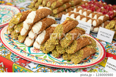 Cannoli with pistachios and ricotta. Sicilian dessert cannolo, fresh sweet cannoli pile Cannoli with pistachios and ricotta. Sicilian dessert cannolo, fresh sweet cannoli pile 128000980
