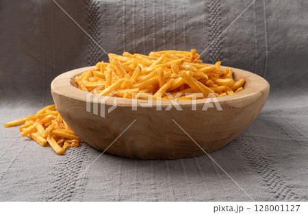 Fried chips sticks, finger potato chips, golden shoestring fries pile, French fries Fried chips sticks, finger potato chips, golden shoestring fries pile, French fries 128001127