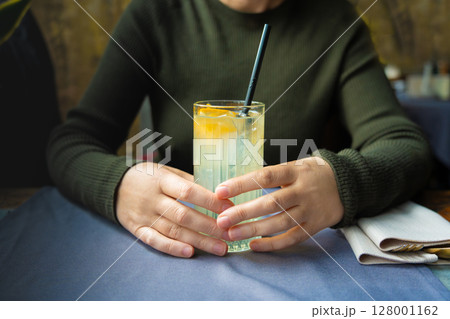 Ice lemonade in tall glass. Yuzu mocktail with lemon and soda, cool lime juice cocktail 128001162