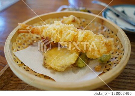Crispy Shrimp and Vegetable Tempura in a Traditional Bamboo Basket. Japanese Fried Food Close-Up 128002490