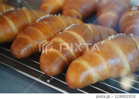 Close-Up of Freshly Baked Salt Butter Rolls with Crusty Surface and Sea Salt on Top Close-Up of Freshly Baked Salt Butter Rolls with Crusty Surface and Sea Salt on Top 128002858