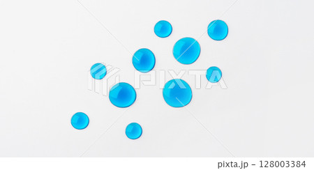 Blue drops of cosmetics on a white background 128003384