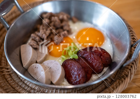 Thai style Skillet egg. A pan fried egg with toppings including Thai pork sausage, ground pork and Chinese sausage. 128003762