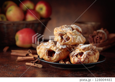 Homemade mini apple strudels with apples and cinnamon. Homemade mini apple strudels with apples and cinnamon. 128004481