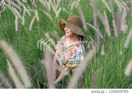 Woman (LGBTQ) posing at flower park garden field 128004765