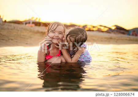 Enjoying joyful moments with family at the beach during sunset Enjoying joyful moments with family at the beach during sunset 128006674