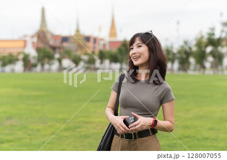 Happy solo Southeast Asian woman and teenager blogger enjoys world travel. tourism concept for local cultural explorer experience in Bangkok Thailand Asia Happy solo Southeast Asian woman and teenager blogger enjoys world travel. tourism concept for local cultural explorer experience in Bangkok Thailand Asia 128007055