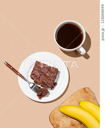 Chocolate banana brownie on a plate on a beige background 128008049