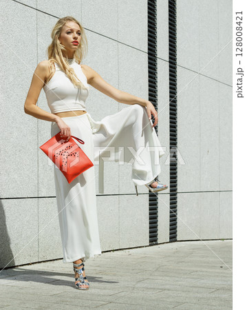 Woman wearing crop top and culottes Woman wearing crop top and culottes 128008421