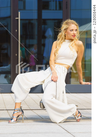 Blonde woman in city Blonde woman in city 128008444