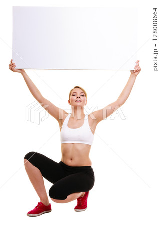 Fitness sporty woman holding blank empty ad banner Fitness sporty woman holding blank empty ad banner 128008664