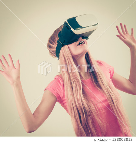Girl wearing virtual reality goggles. Girl wearing virtual reality goggles. 128008812