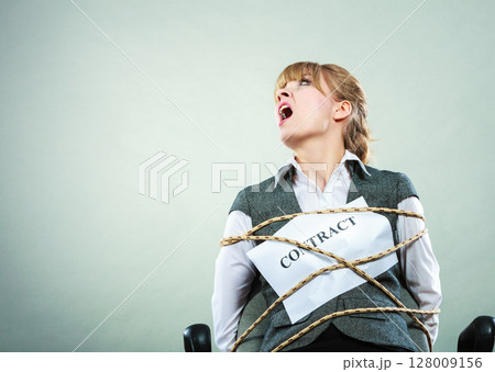 Afraid businesswoman bound by contract terms. Afraid businesswoman bound by contract terms. 128009156