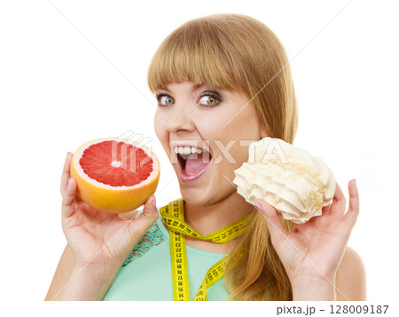 Woman choosing fruit or cake make dietary choice Woman choosing fruit or cake make dietary choice 128009187