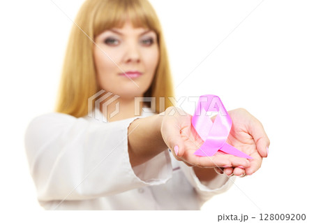 Doctor showing pink cancer awareness ribbon Doctor showing pink cancer awareness ribbon 128009200