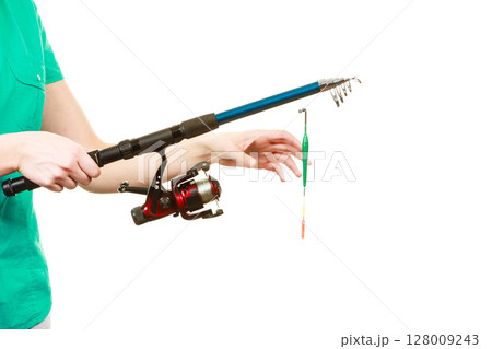 Person holding fishing rod, spinning equipment. 128009243