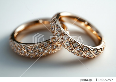 Pair of white gold wedding rings on a white background. Pair of white gold wedding rings on a white background. 128009297