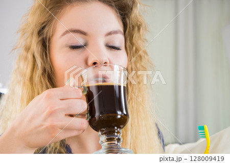 Funny woman being late drinking coffee Funny woman being late drinking coffee 128009419