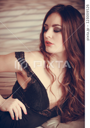 Seductive young woman in lingerie in bed. Seductive young woman in lingerie in bed. 128009526