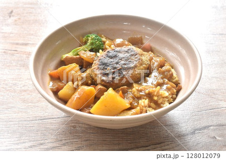 hamburg crispy fried chop pork with boiled vegetable topping plain rice dressing potato and carrot in Japanese curry on bowl 128012079