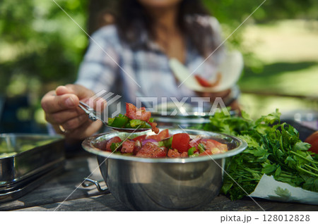 Close-Up of Fresh Vegetable Salad Being Served Outdoors on a Sunny Day 128012828
