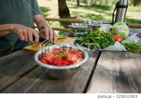 Outdoor Vegetable Preparation on Wooden Table in Sunny Nature Outdoor Vegetable Preparation on Wooden Table in Sunny Nature 128012883
