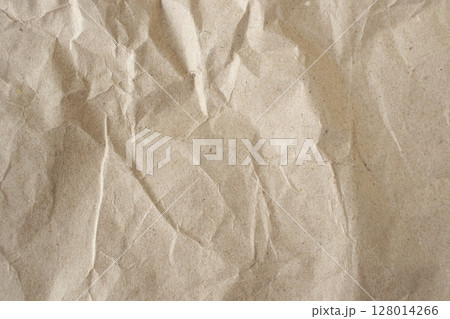 Brown crumpled paper texture or background for design with copy space for text, top view. Packaging material. 128014266