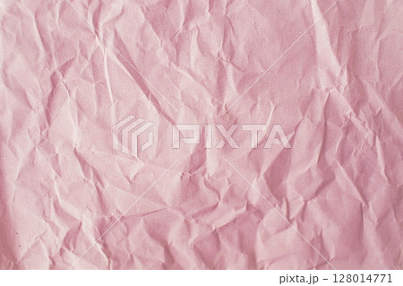 Pink crumpled paper background. Texture of crumpled paper, top view, copy space. 128014771