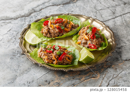 Asian Ground Beef Lettuce Wraps cups with vegetables close-up on the plate. Horizontal 128015458