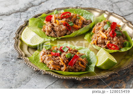 Ground Beef Lettuce Wraps with vegetables close-up on the plate. Horizontal Ground Beef Lettuce Wraps with vegetables close-up on the plate. Horizontal 128015459