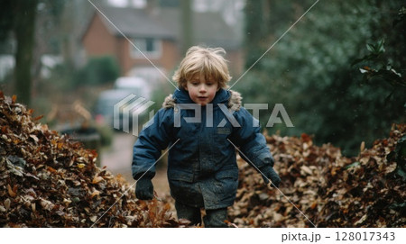 A Joyful Toddler Playing in Autumn Leaves A Joyful Toddler Playing in Autumn Leaves 128017343