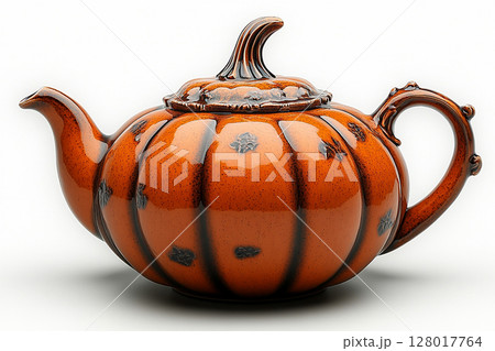 Ceramic teapot in shape of a orange pumpkin in a rustic style on a white background. 128017764