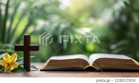 Reflection on faith with a wooden cross and open book on a rustic table with natural light 128017850