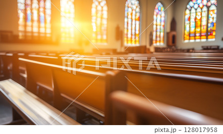Sunlight streaming through stained glass windows inside a church during morning service 128017958