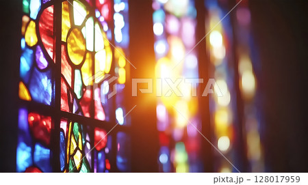 Colorful stained glass windows illuminating a church interior during the afternoon light 128017959