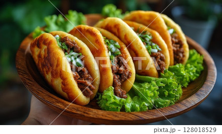 Savory Mini Beef Tacos on Wooden Plate 128018529