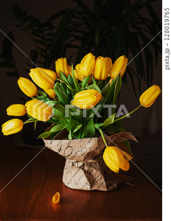 yellow tulips on a wooden background yellow tulips on a wooden background 128019765