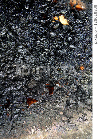 Close up of heavy black rust on a brass base of a kitchen sauce pan abstract background Close up of heavy black rust on a brass base of a kitchen sauce pan abstract background 128019839