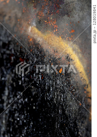 Close up of heavy black rust on a brass base of a kitchen sauce pan abstract background 128019841