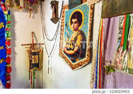 Religious objects on the wall of a house Religious objects on the wall of a house 128020403