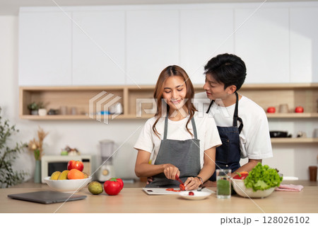 Couple Cooking Together with Fresh Ingredients in Modern Kitchen. Love and joy in food preparation. 128026102