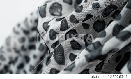 A monochrome print midi dress featuring leopard spots in shades of grey. The flowy silhouette and high neckline make it a stylish and refined choice for any occasion 128026341