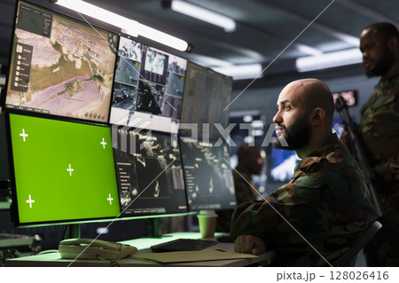 Counterterrorism division operative using target acquisition tech on isolated screen gear to detect enemy location. Defense security expert using chroma key satellite hardware to track threats Counterterrorism division operative using target acquisition tech on isolated screen gear to detect enemy location. Defense security expert using chroma key satellite hardware to track threats 128026416